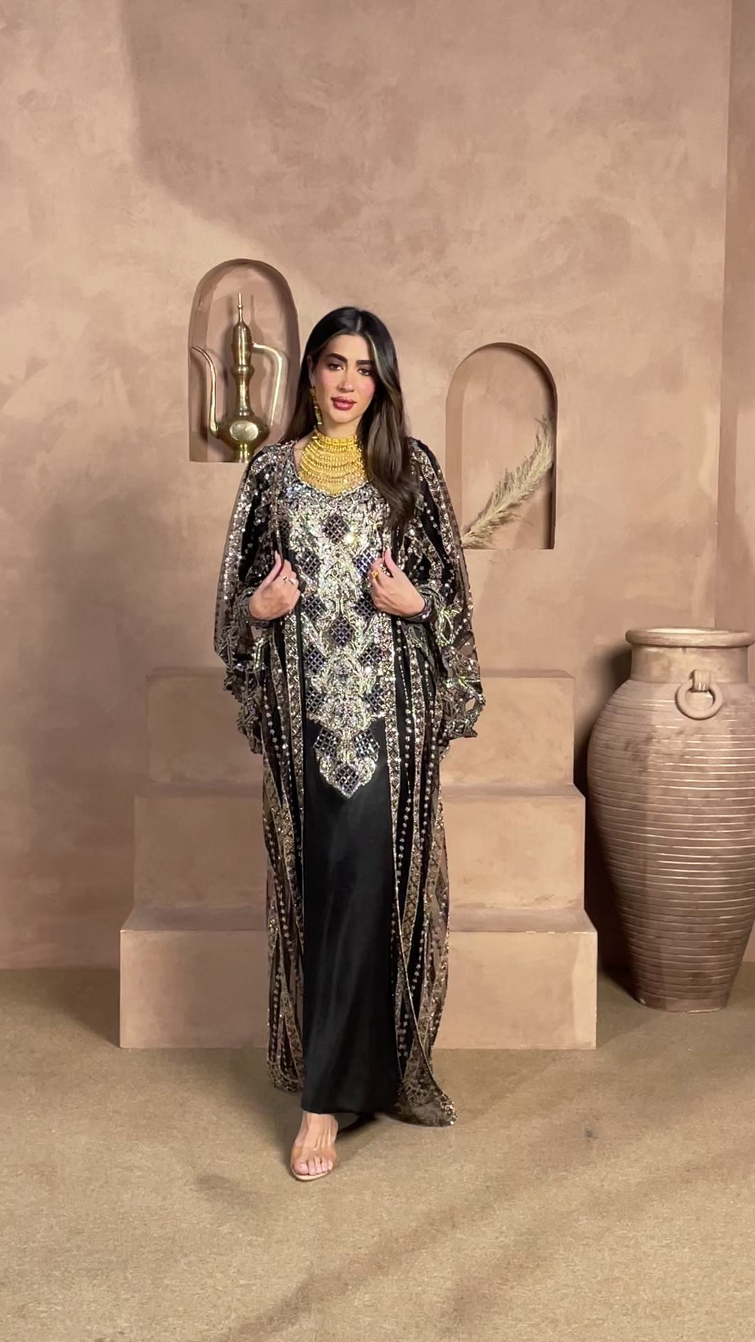 Midnight black luxury kaftan featuring intricate silver embroidery and embellished cape-style sleeves, perfect for Eid, weddings, receptions, and formal evening occasions.