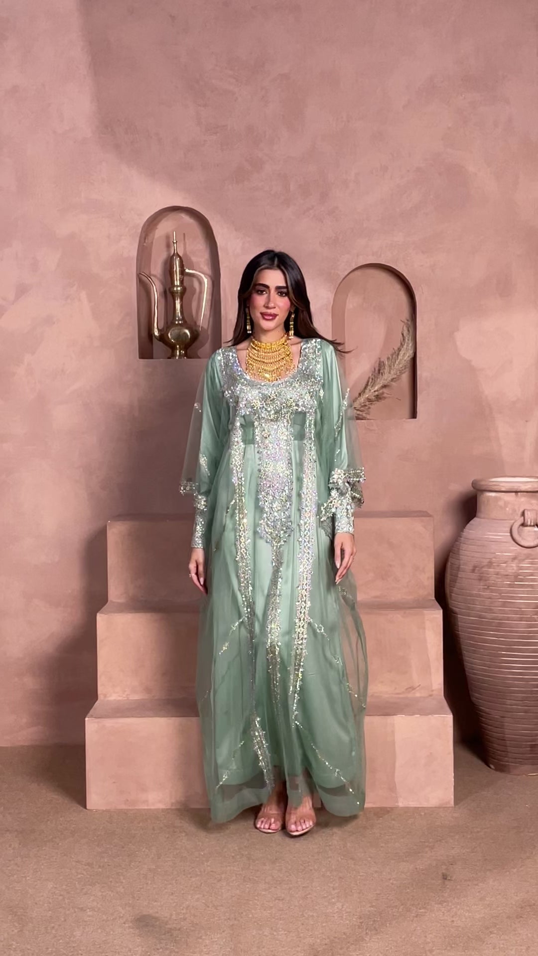 Mint green luxury kaftan with crystal and silver embellishments, featuring a sheer cape overlay and elegant modest silhouette for Eid, weddings, and formal occasions.