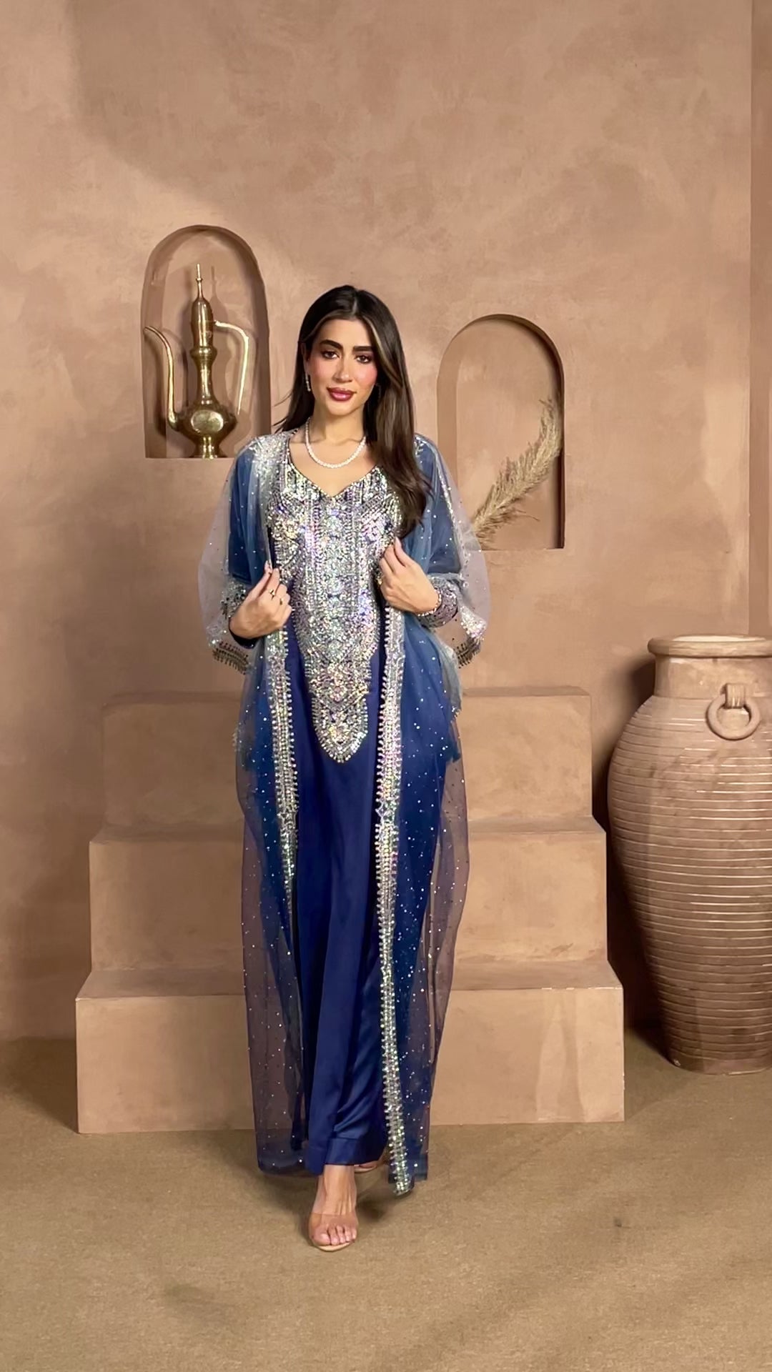 Royal navy blue kaftan with intricate silver embellishments and a sheer crystal-studded cape overlay, ideal for Eid, weddings, receptions, and luxury evening occasions.